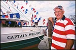 Photo: Wilson Acosta stands beside his shrimp boat.